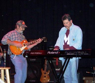 Doc playing the guitar and Bill on keyboards.