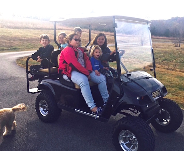 cousins on a golf cart