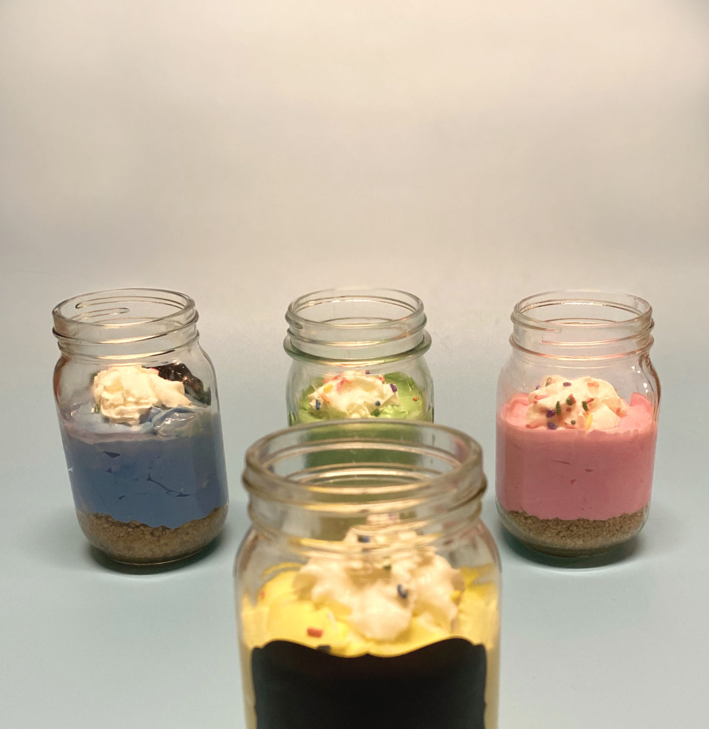 multi color cheesecake in mason jars 
