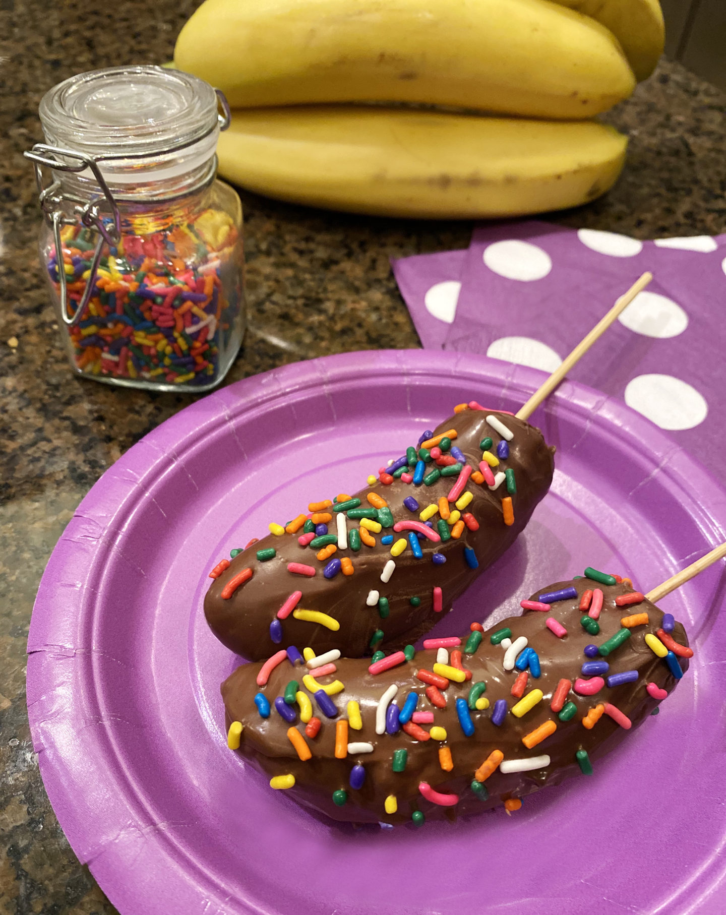 chocolate dipped banana with rainbow sprinkles