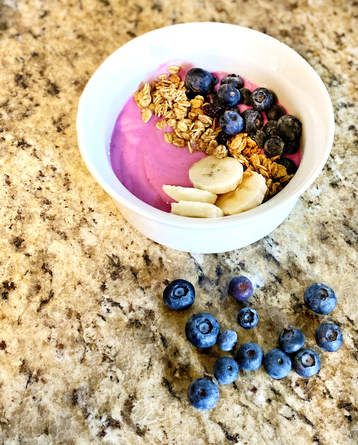 dragon fruit smoothie bowl with blueberry and banana toppings 