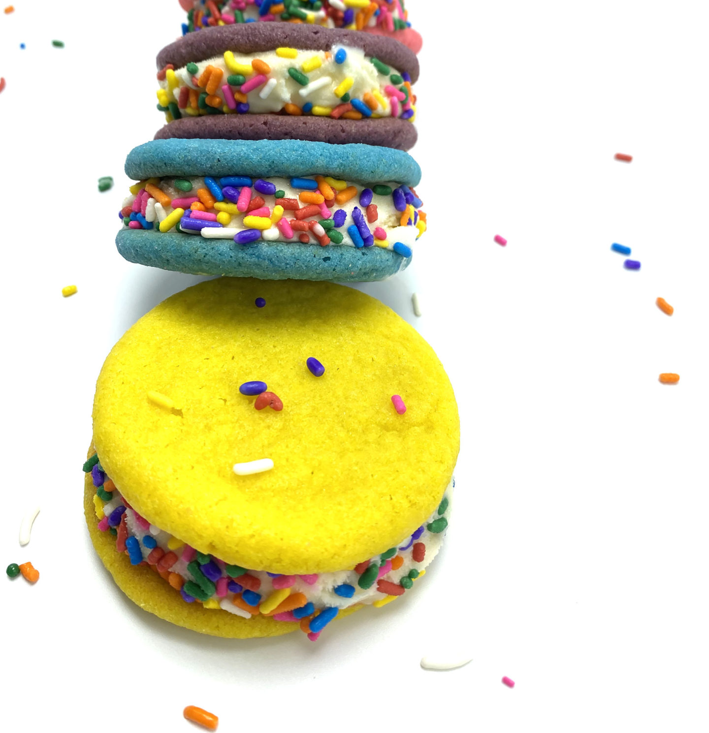 closeup of colorful sugar cookie ice cream sandwiches and rainbow sprinkles