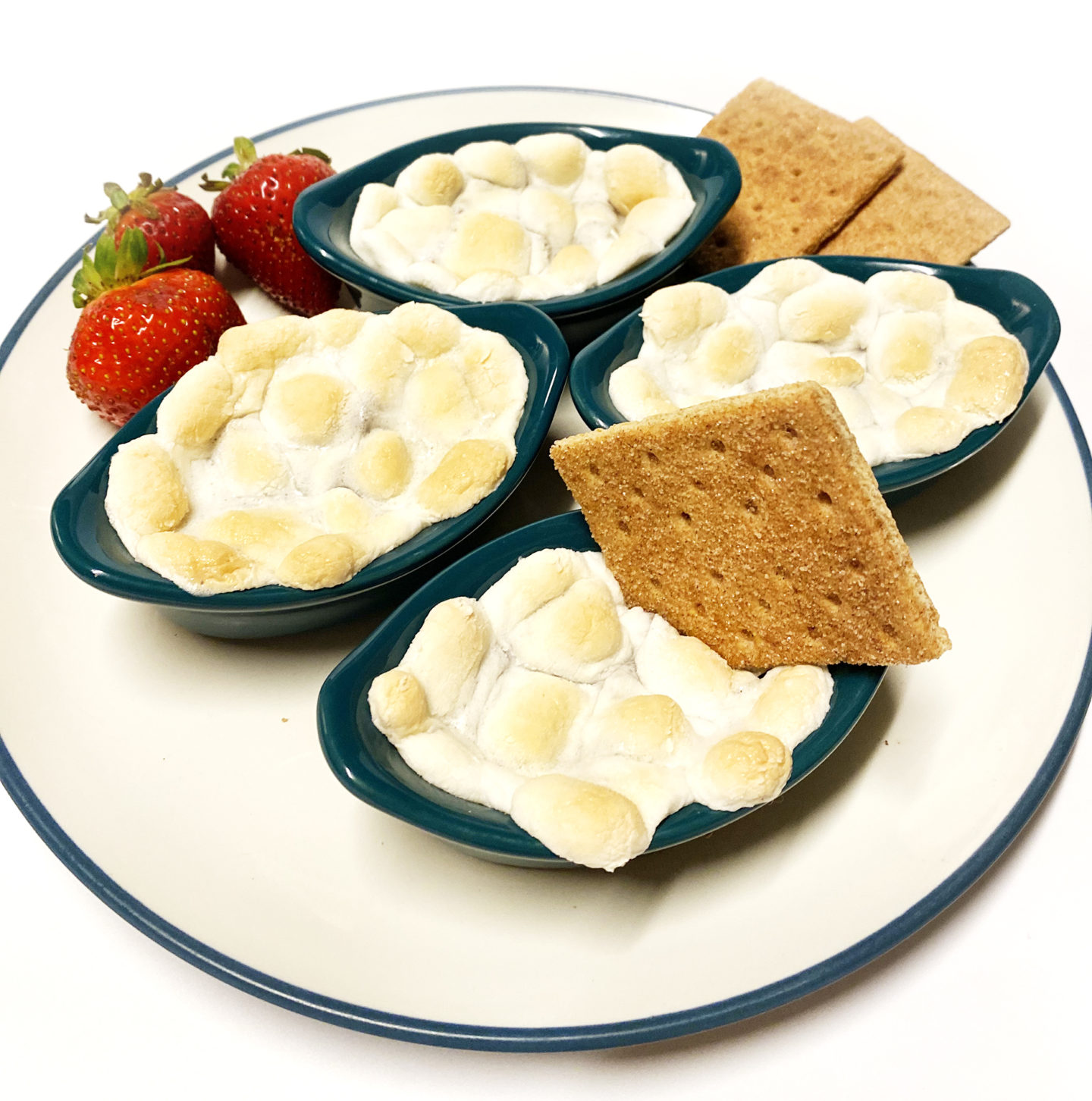 s'mores dessert dip with graham crackers and strawberries 