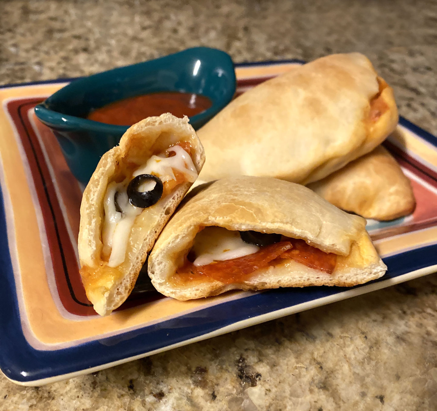 mini calzone with pepparoni cheese and black olives square