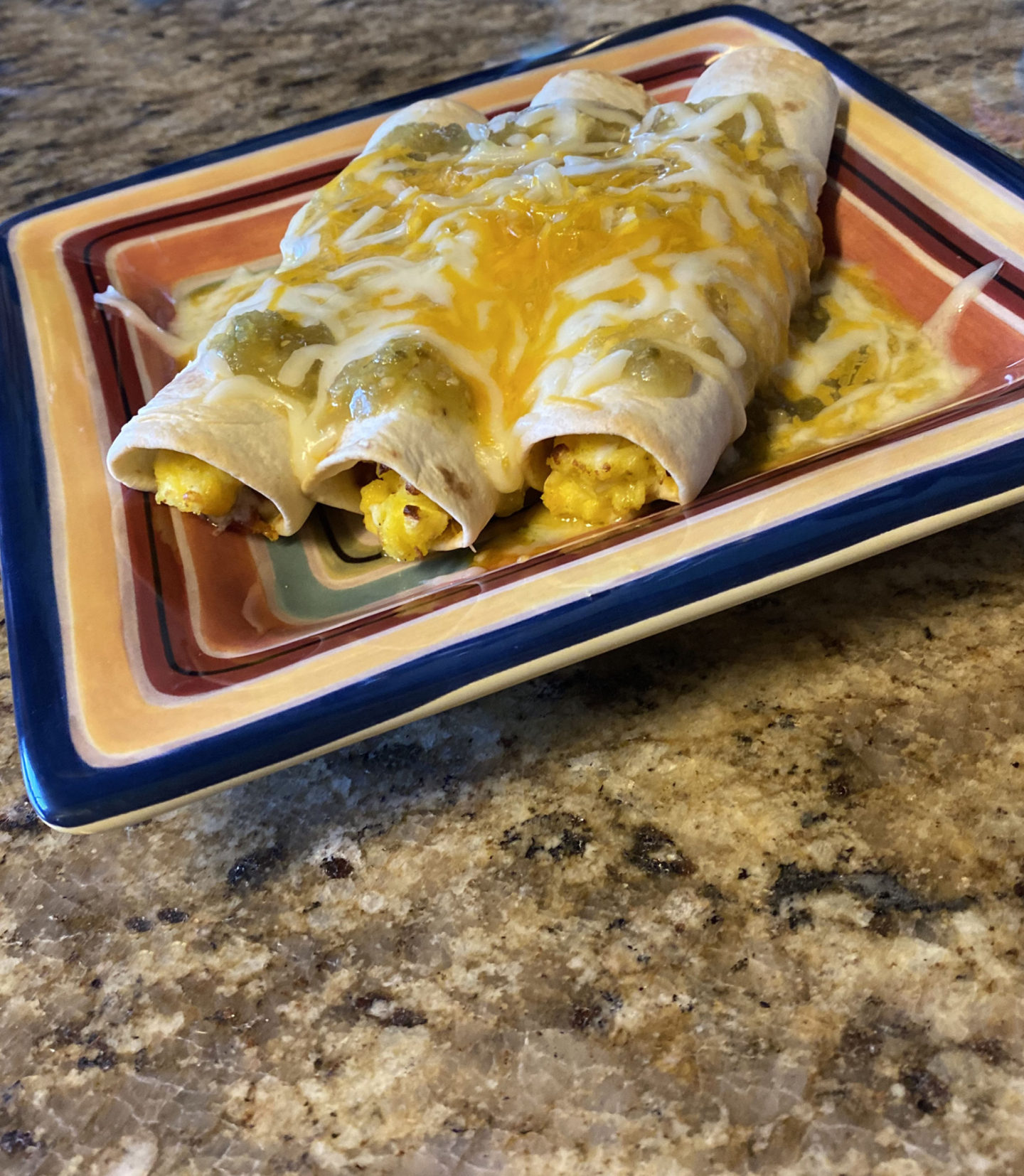 smothered egg taquitos on a plate