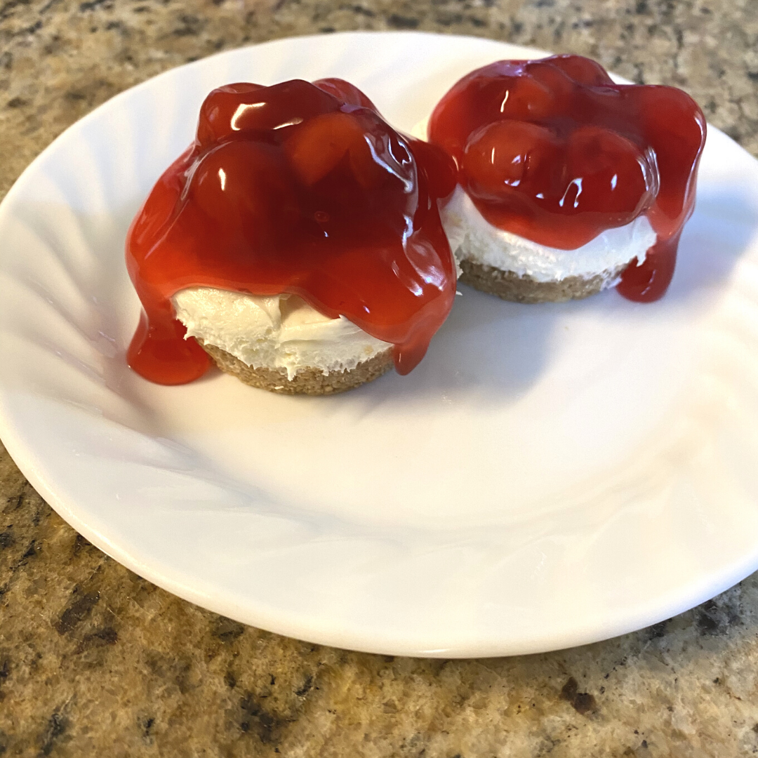2 Mini cherry cheesecakes on a plate