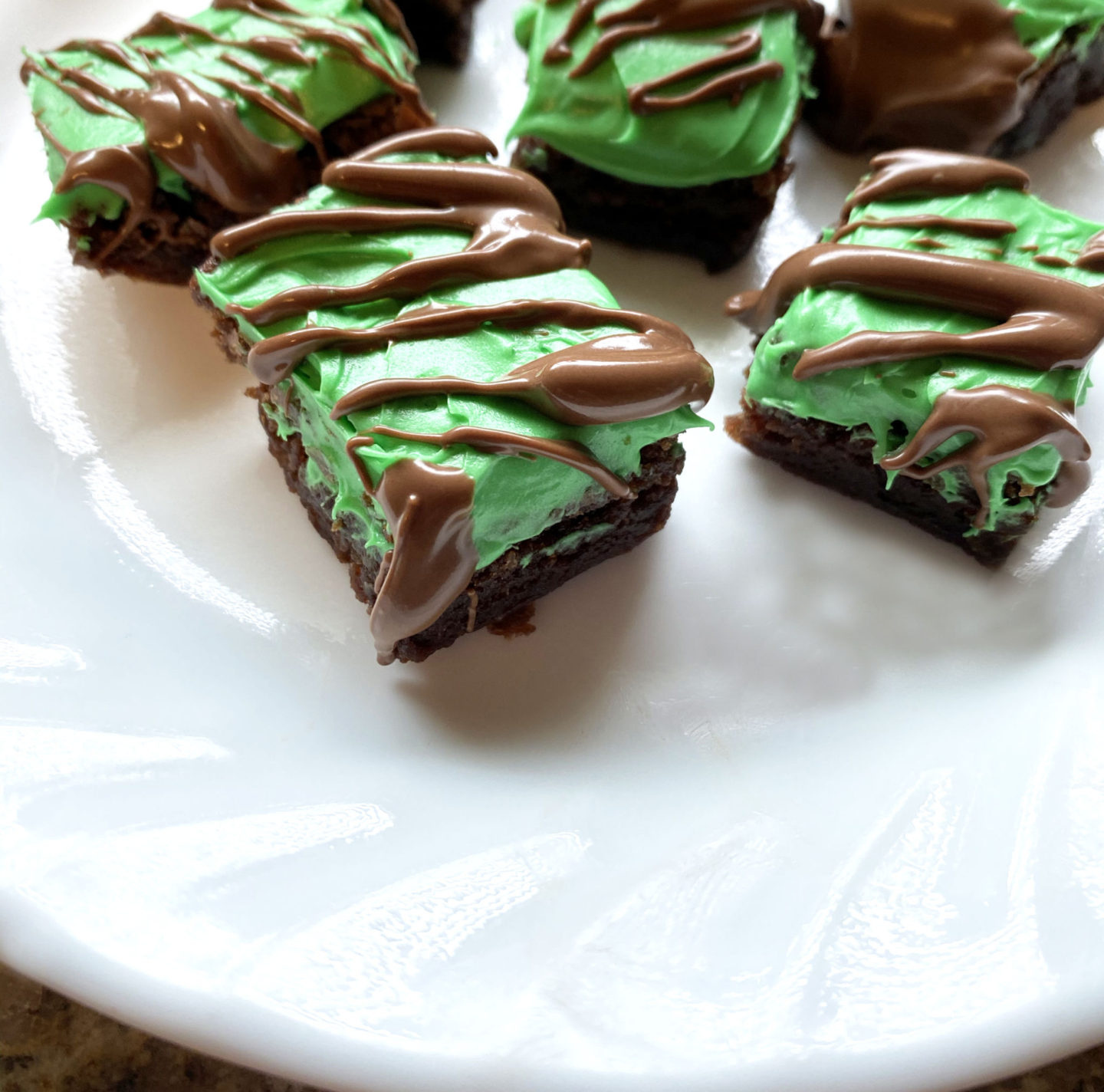 creme de menthe brownies with green frosting and chocolate drizzle