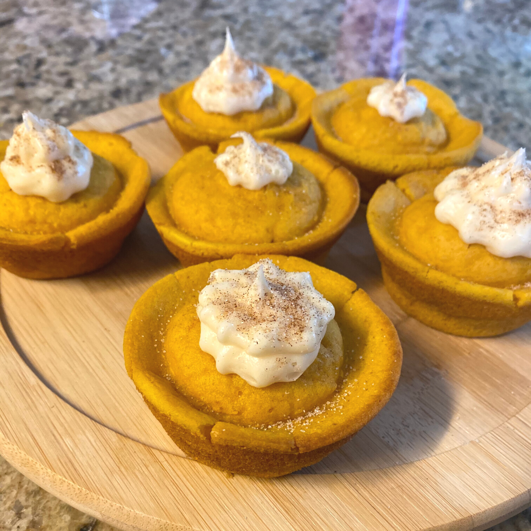 plate of pumpkin spice muffins with cream cheese frosting 