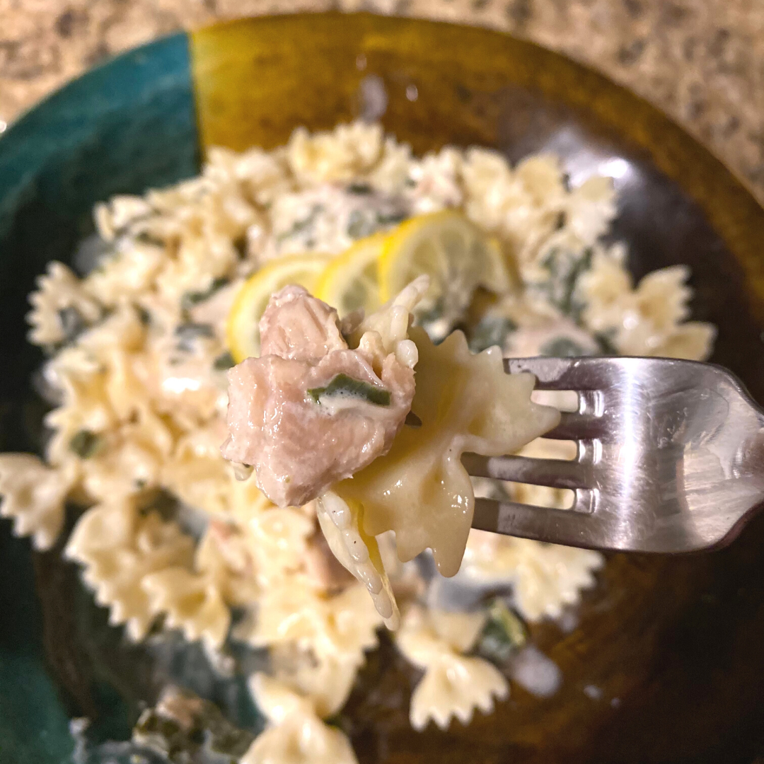 creamy lemon herb chicken on a bed of pasta