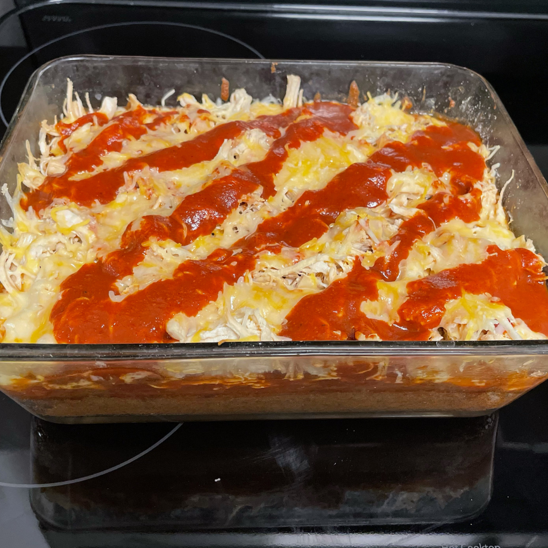 top view of open faced chicken enchilada in a casserole dish