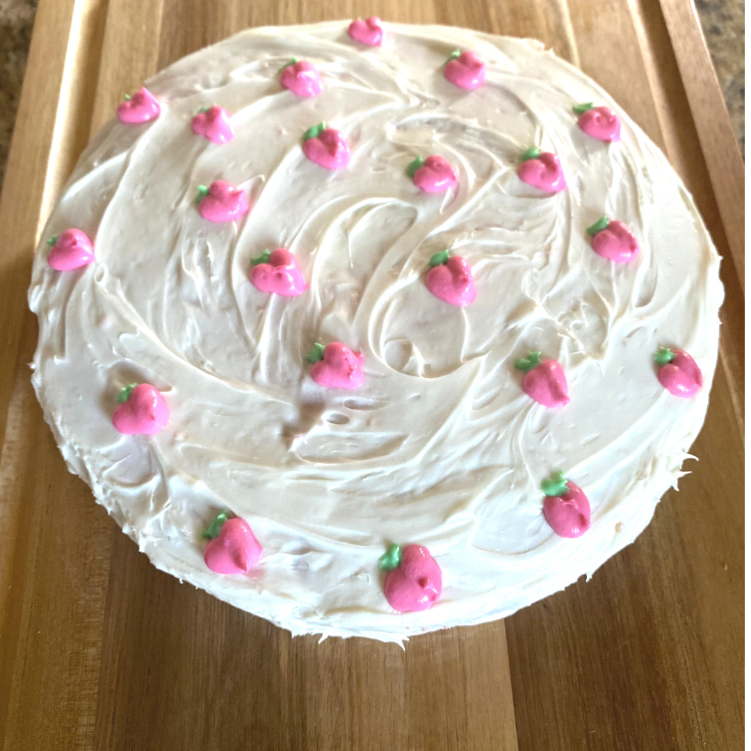 strawberry cake with white buttercream frosting