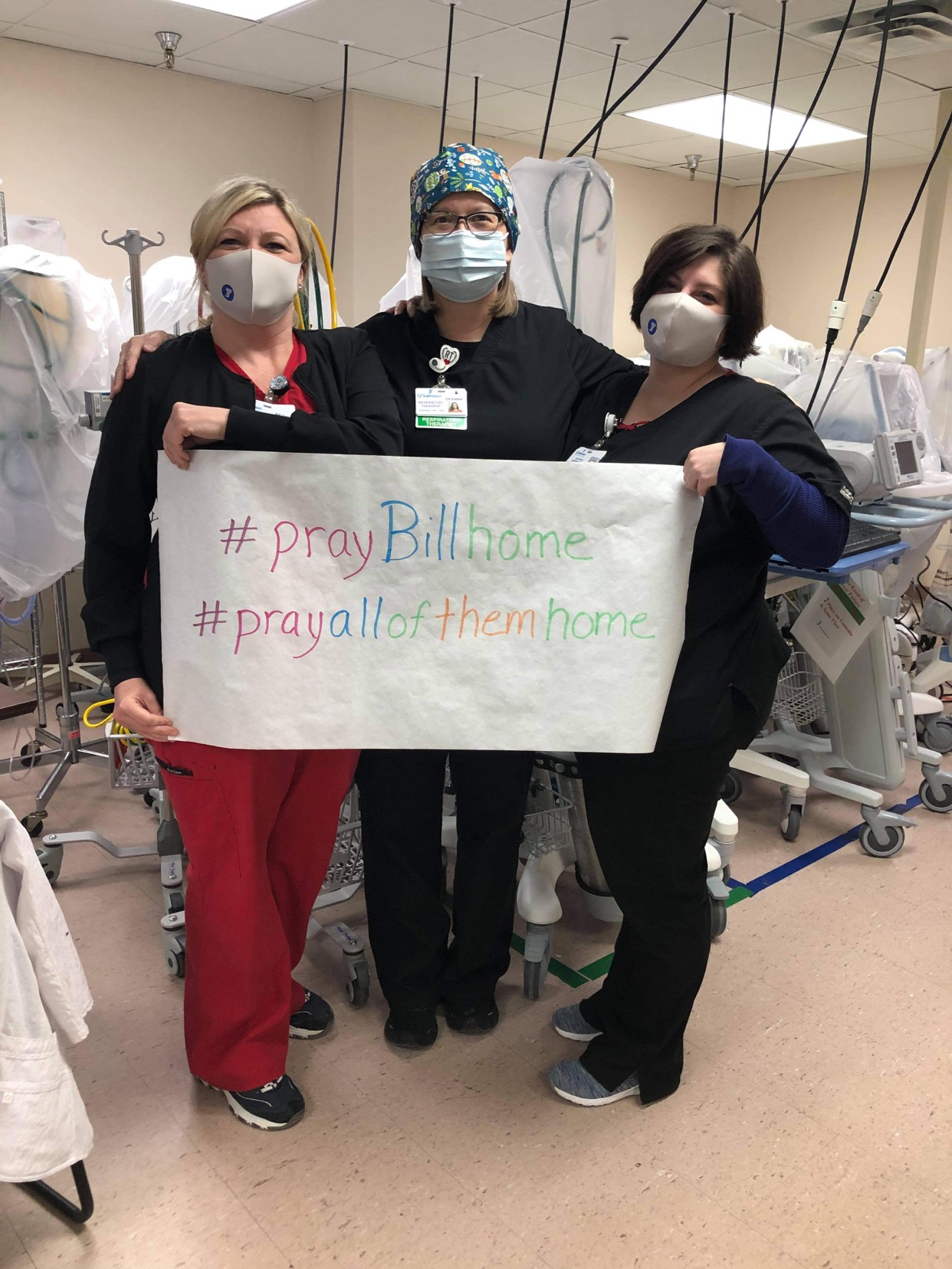 healthcare workers holding sign for #praybillhome