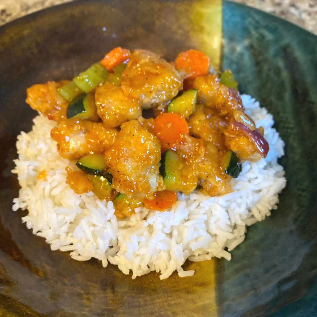 bowl of sweet and sour chicken with rice