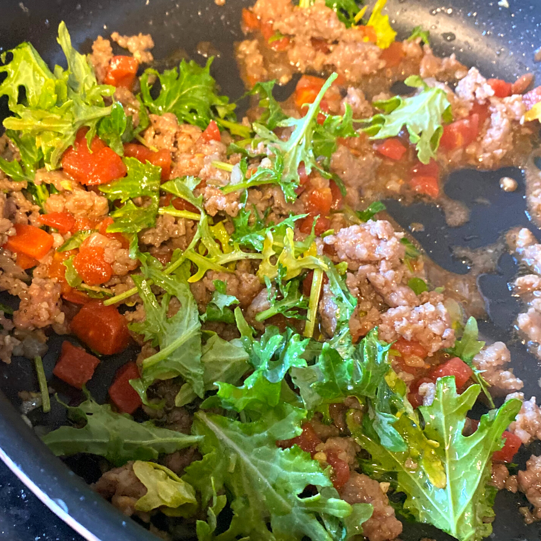 sweet Italian sausage kale and tomatoes in saute pan