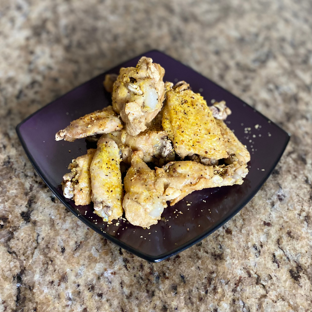 a plate of lemon pepper chicken wings on a plate