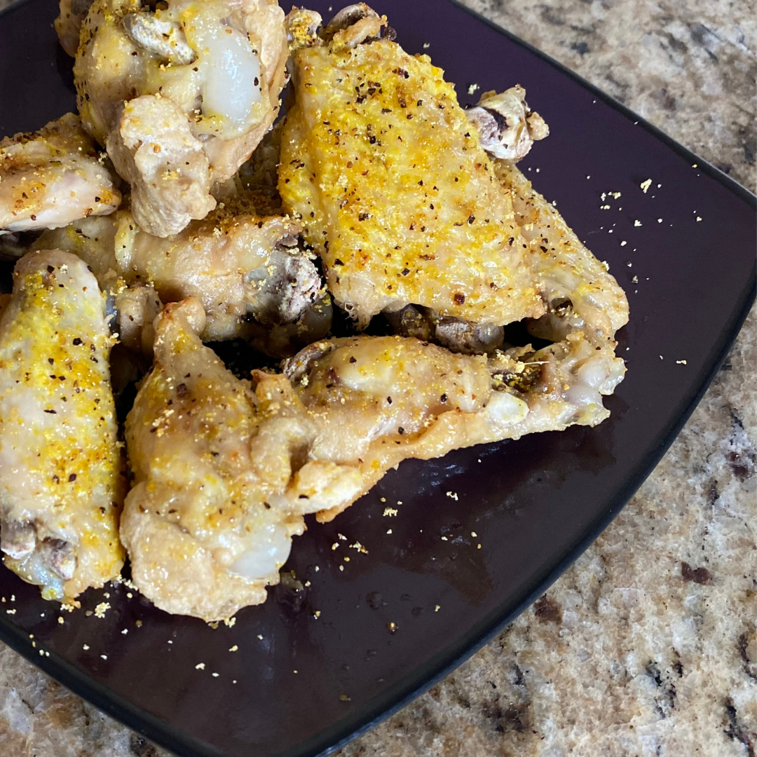 close up of lemon pepper chicken wings on a plate
