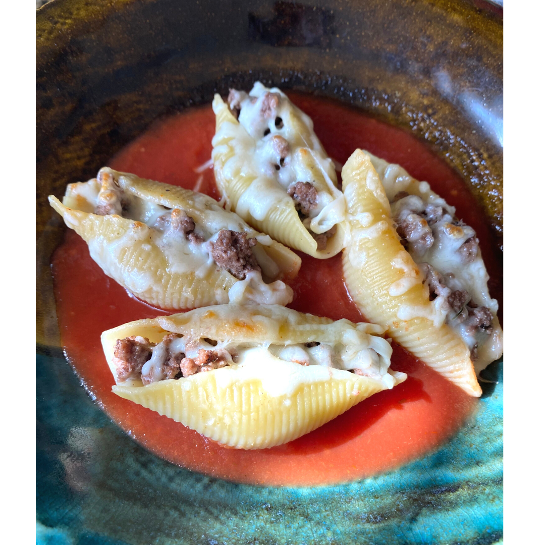stuffed pasta shells with beef and cheese in bowl