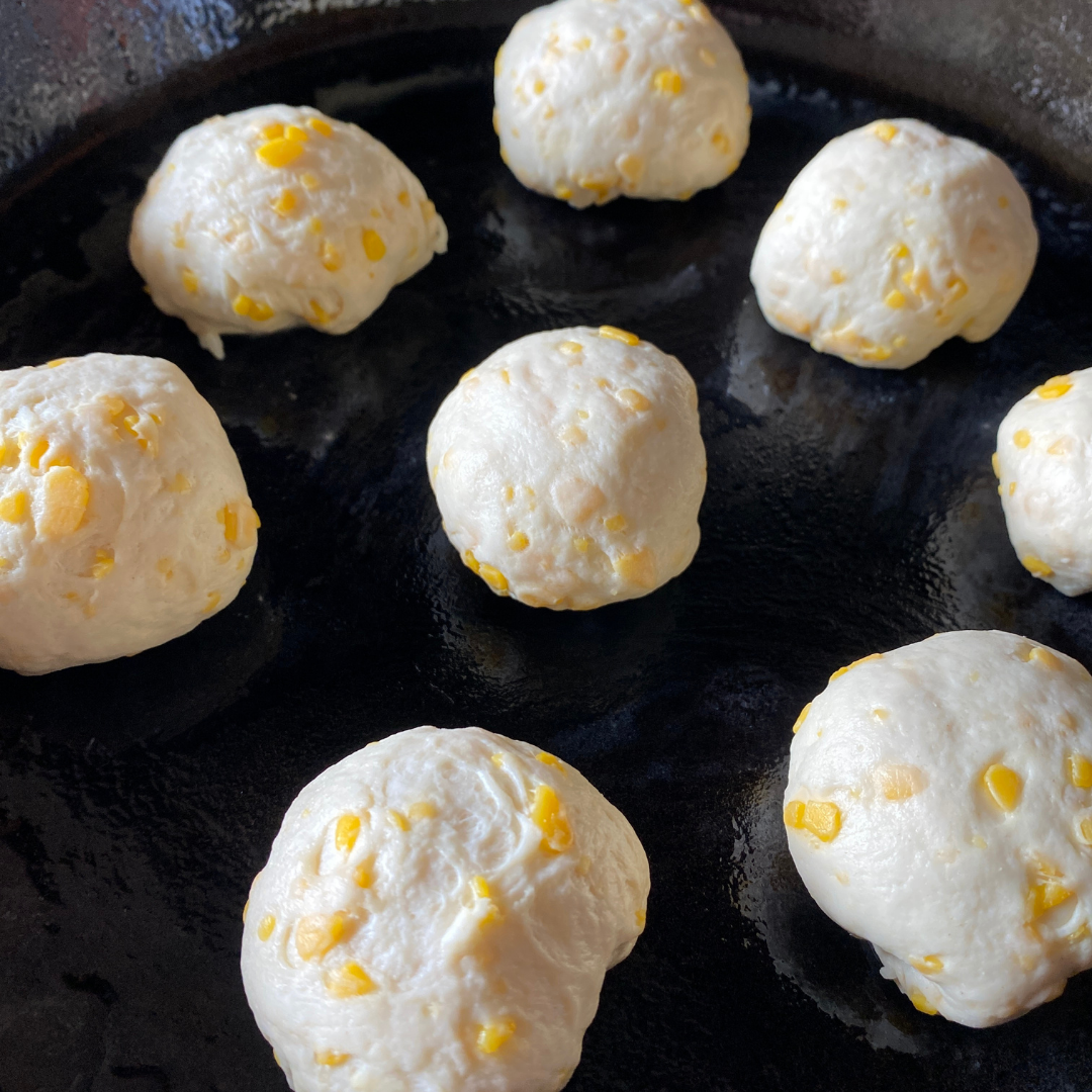 cheese stuffed dough balls in skillet