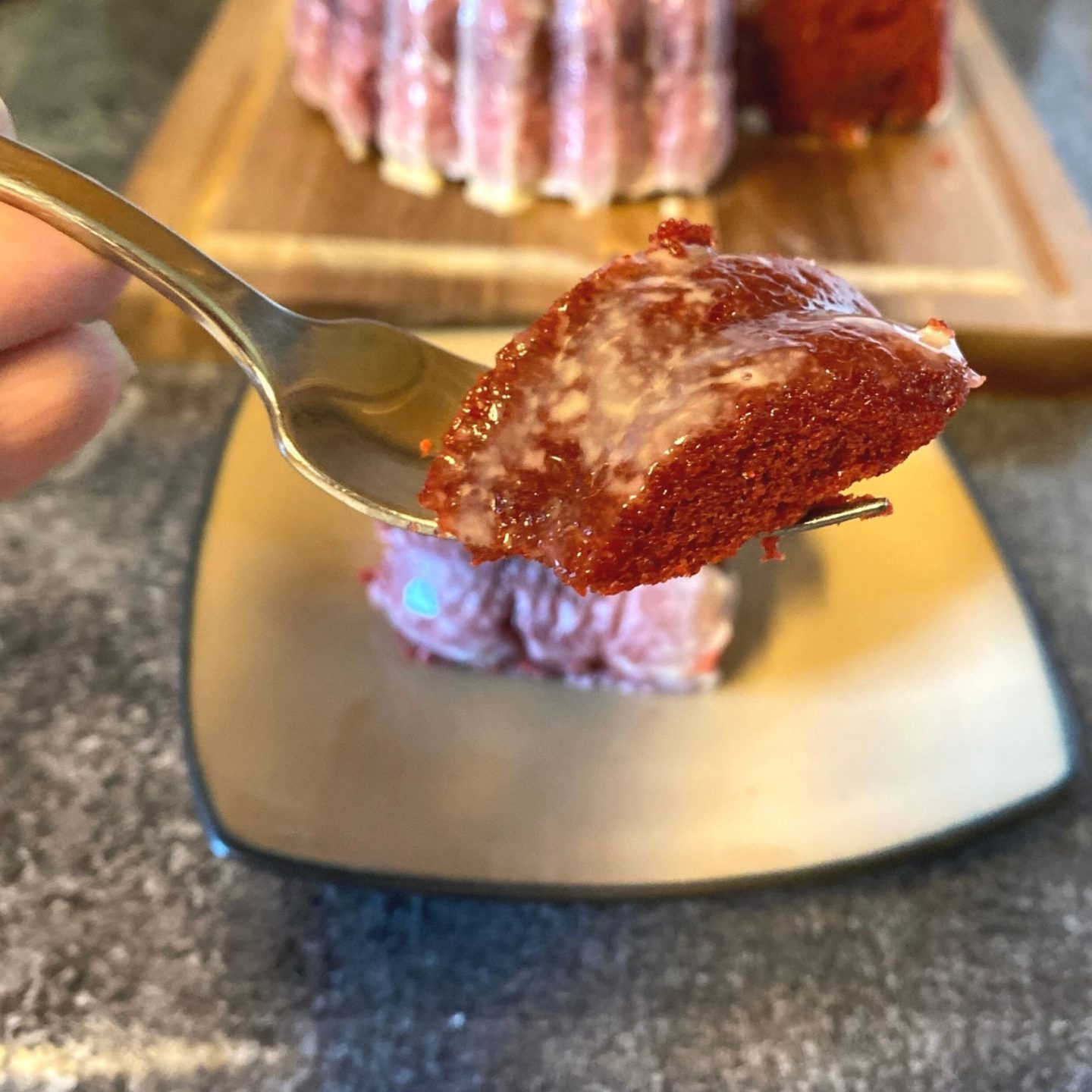 close up of red velvet bundt cake piece on fork