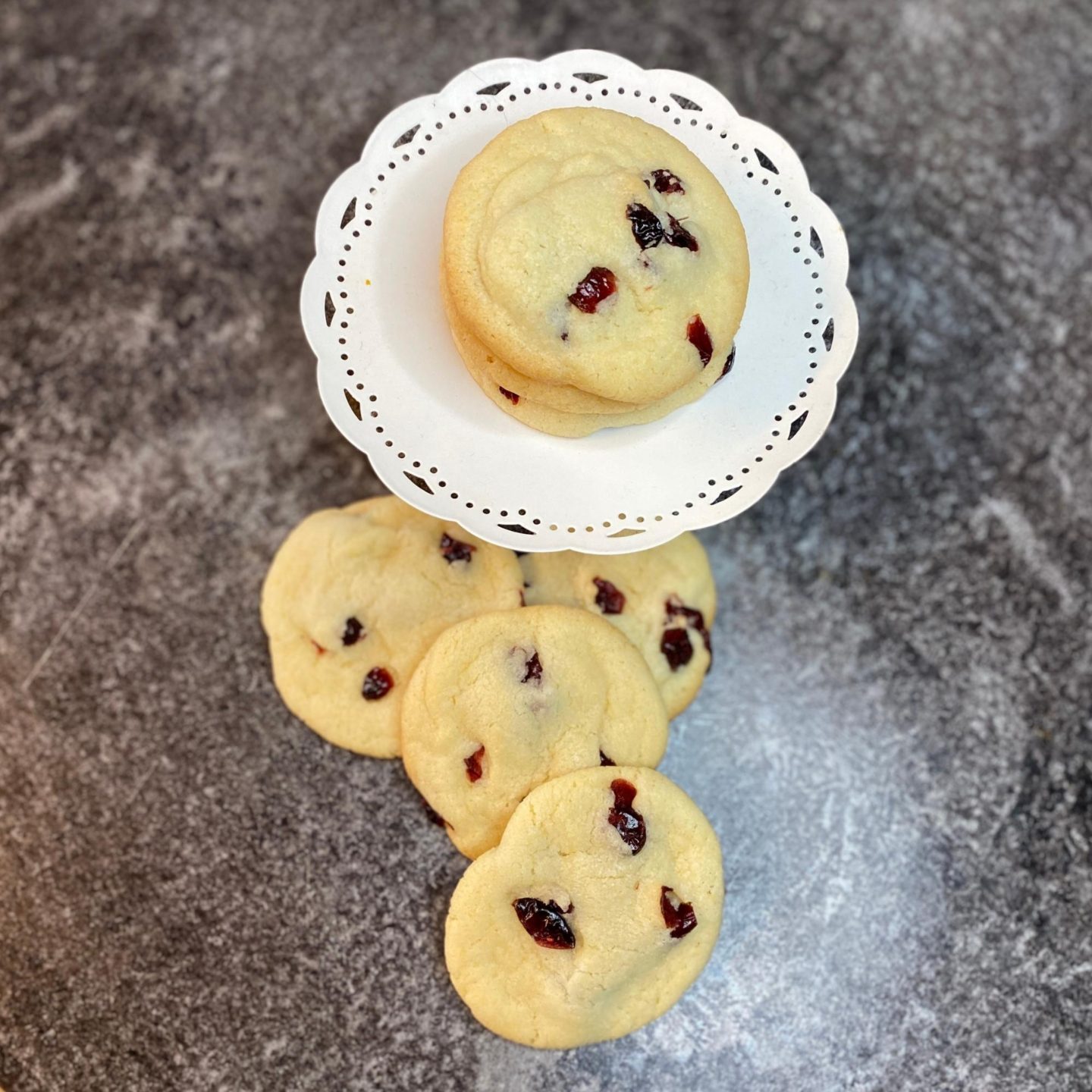 sugar cookies with cranberries on a counter