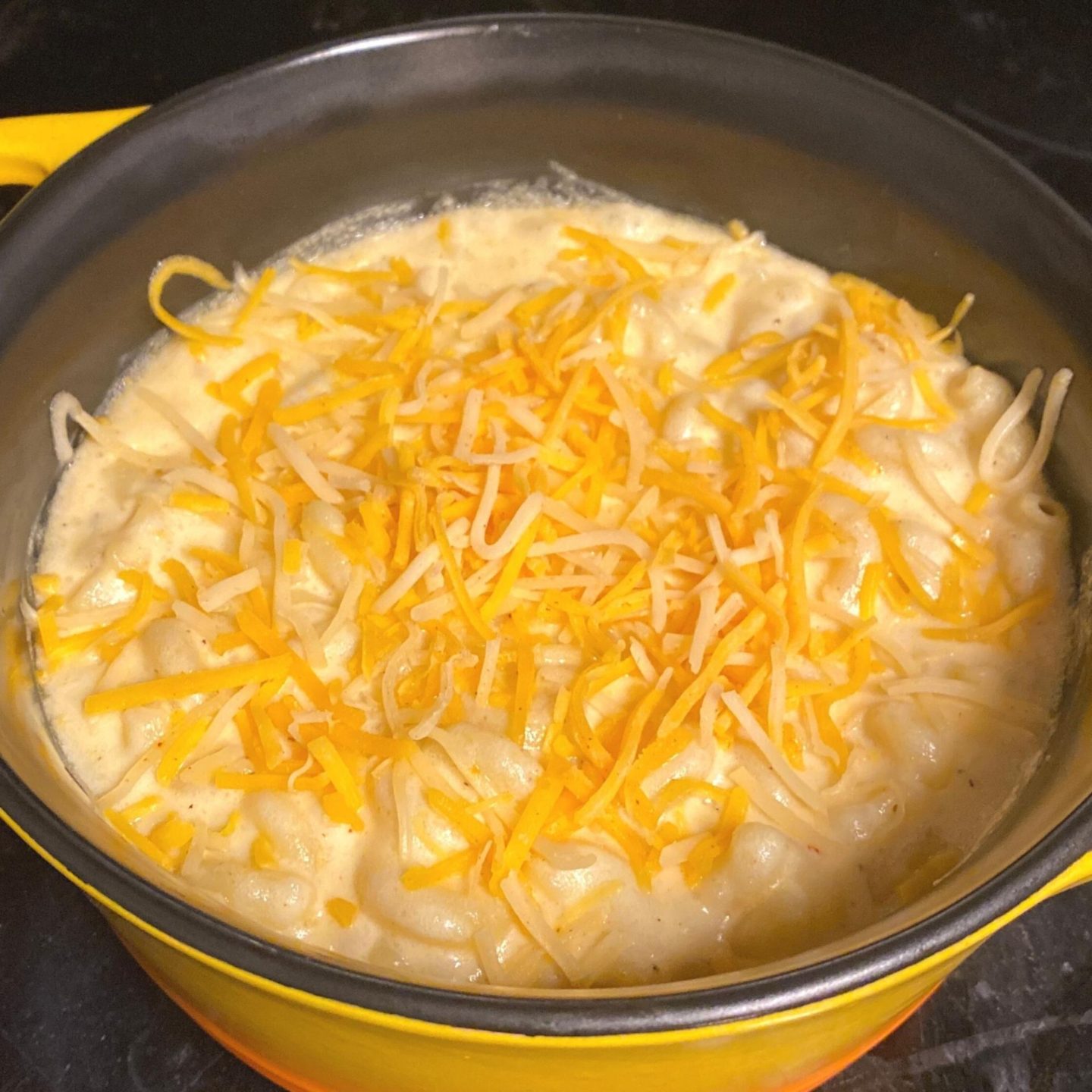 baked mac n cheese with shredded cheese on top