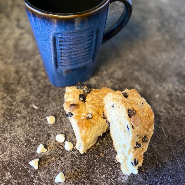 white chocolate blueberry scones with blue coffee mug