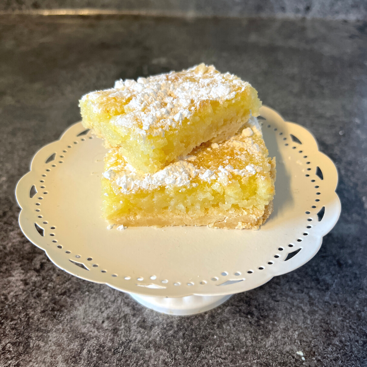 2 lemon bars stacked on white dish