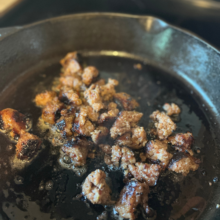 sausage cooking in pan