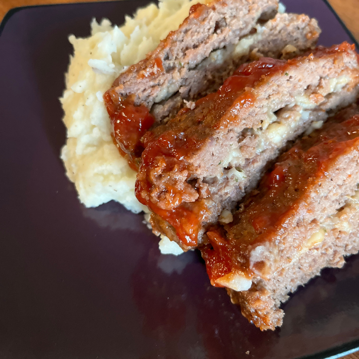 3 slices of meatloaf and mashed potatoes on plate