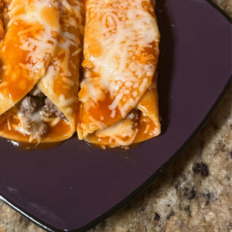 close up of 2 spicy beef enchiladas on plate