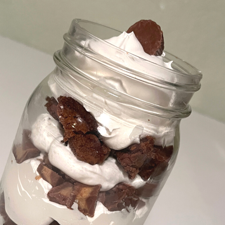 chocolate peanut butter cool whip dessert layered in mason jar