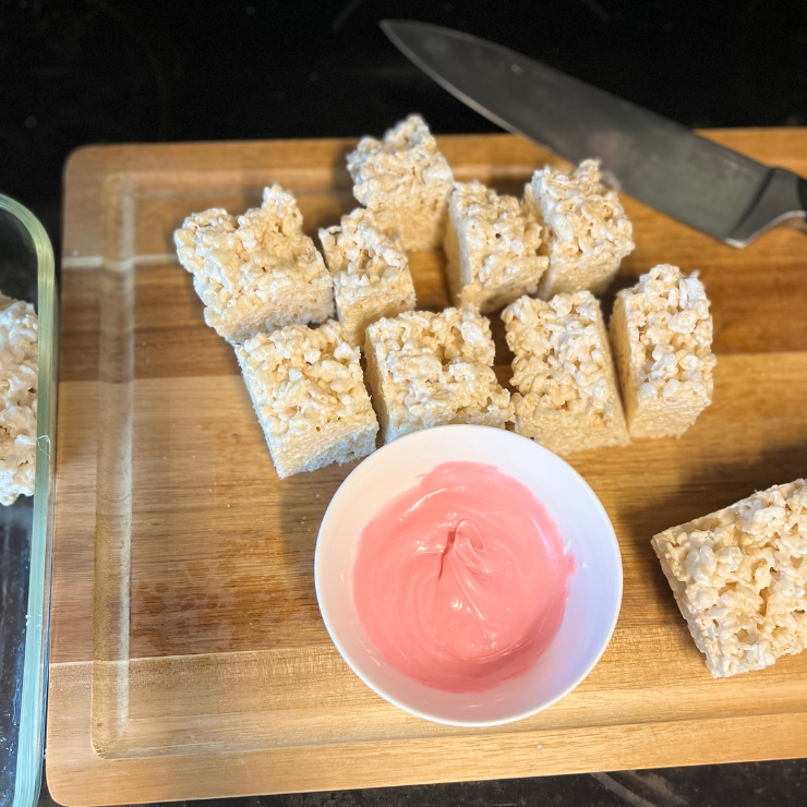 cut rice krispies treats and pink chocolate dip