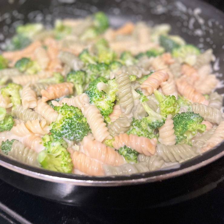 pasta and broccoli in parmesan cream sauce in pan