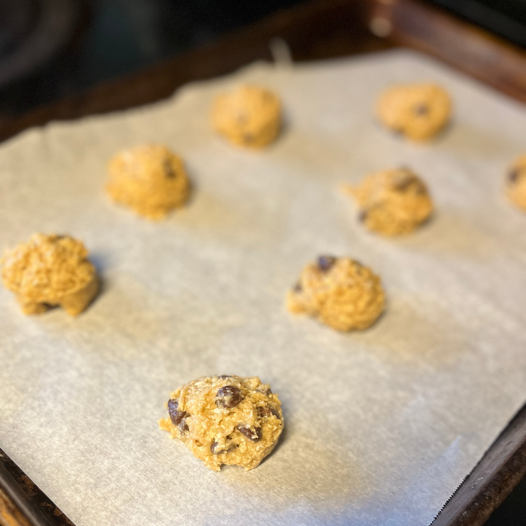 oatmeal chocolate chip cookie dough balls on cookie sheet