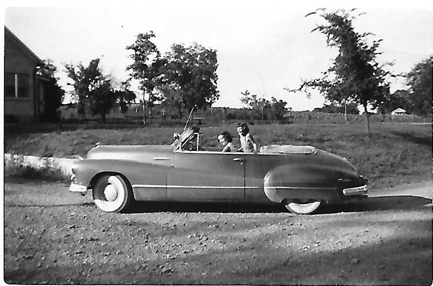 girls riding in convertible classic car